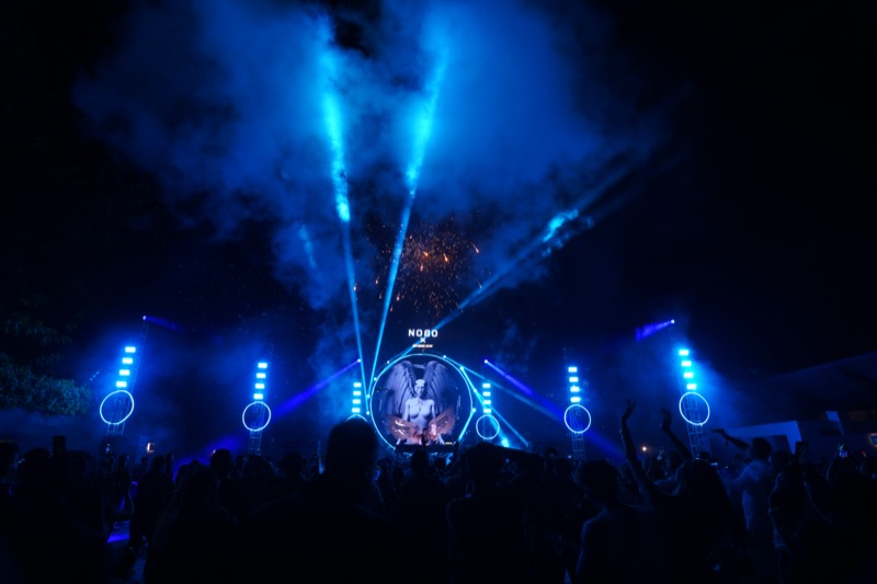 Nobo Music Festival — angel visual, blue beams, haze, crowd